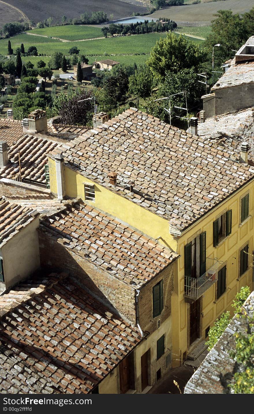 Cortona rooftops with field at the background, Italy