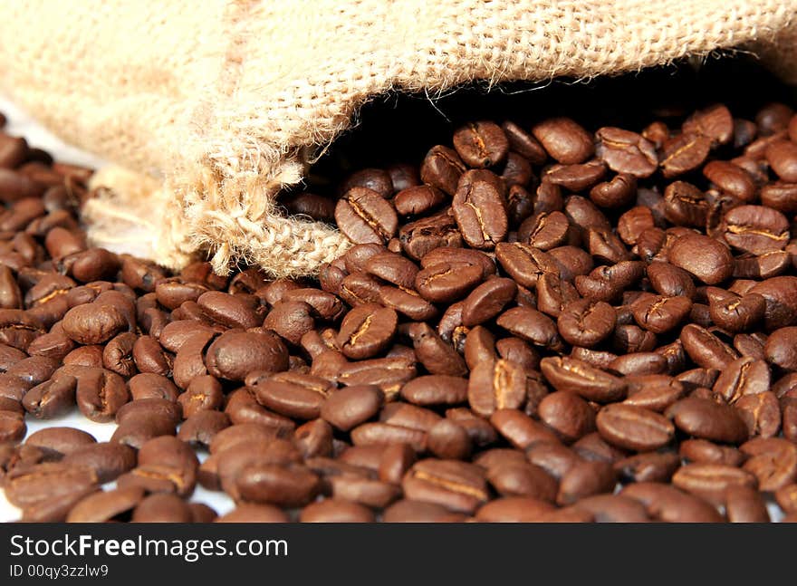 Brown, aromatic coffee beans in a gunnysack. Brown, aromatic coffee beans in a gunnysack