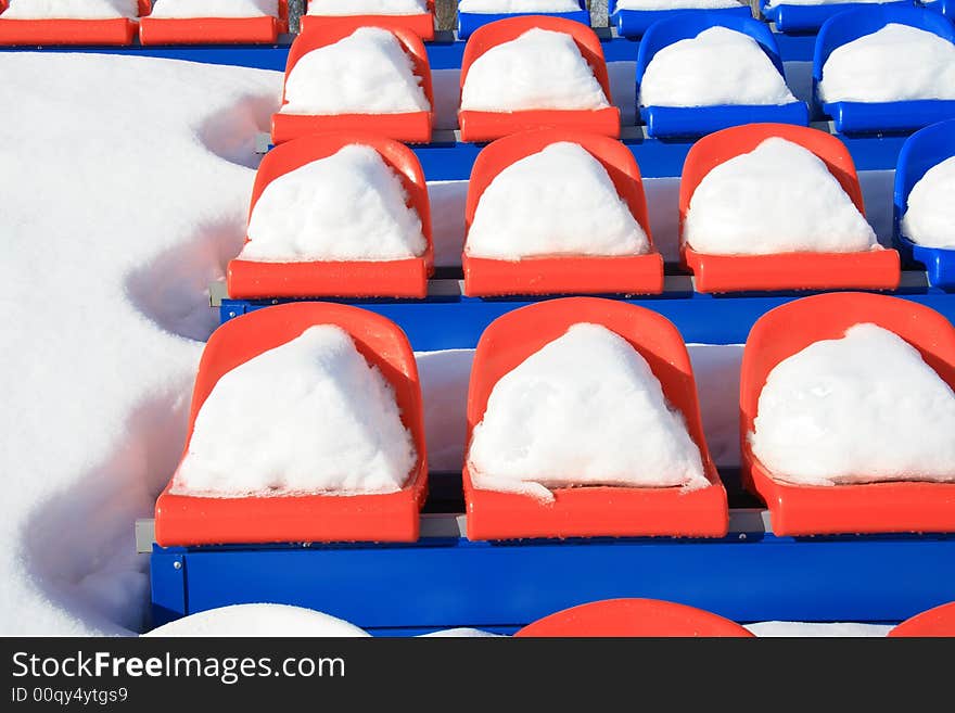 Seats on tribunes of stadium under a snow. Seats on tribunes of stadium under a snow