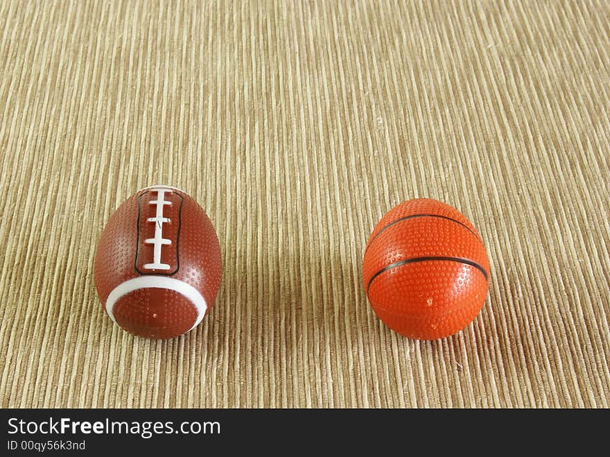 Football and basketball shaped like easter eggs on natural woven background. Looks like they're getting ready to race down the field. Football and basketball shaped like easter eggs on natural woven background. Looks like they're getting ready to race down the field.