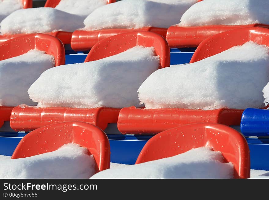 Seats on tribunes of stadium under a snow. Seats on tribunes of stadium under a snow