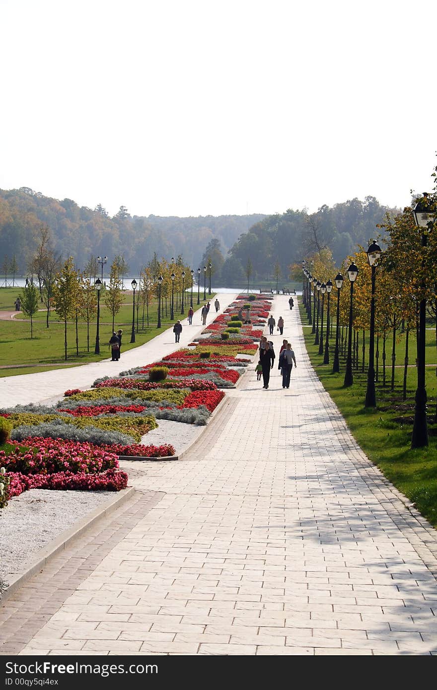 The people walking on paths of park. Summer. Warm.