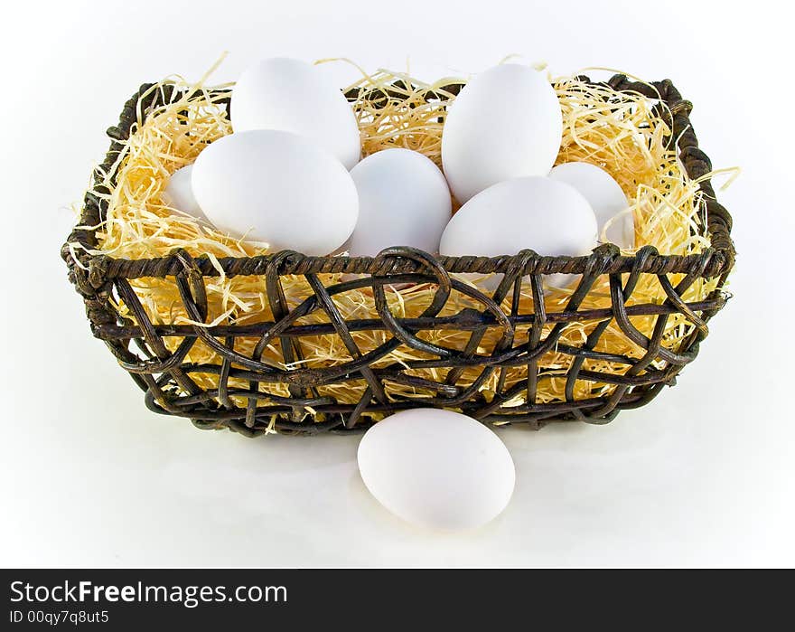 White eggs in a basket over white