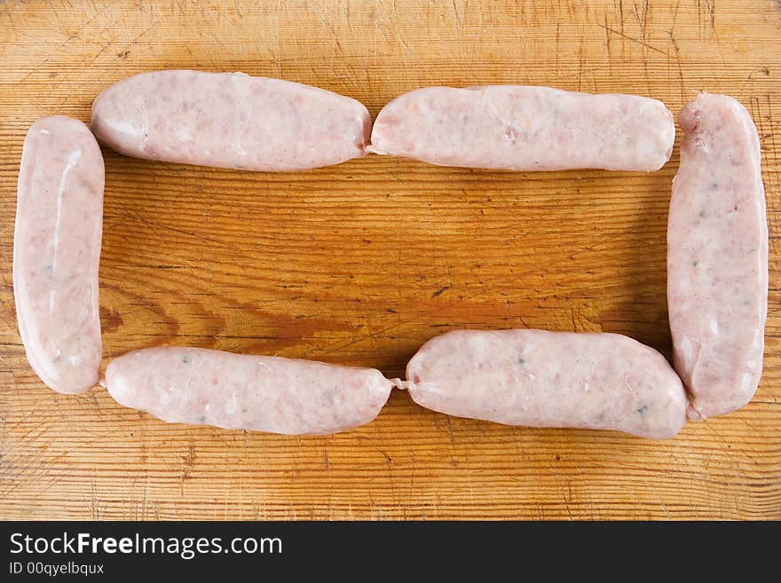 Six uncooked sausages