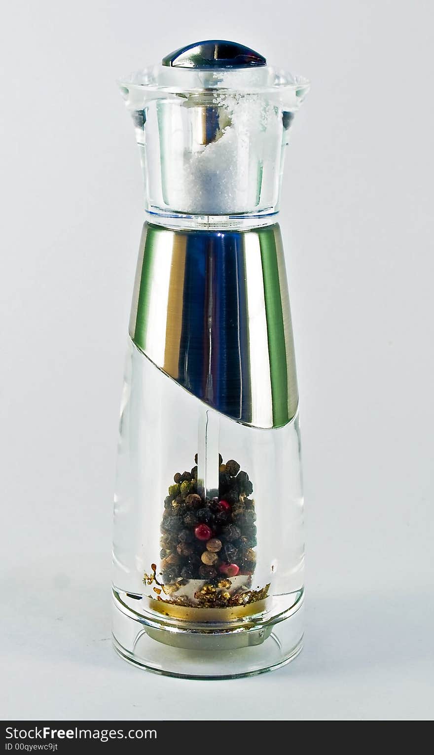 Pepper mill with salt shaker on top over white. Pepper mill with salt shaker on top over white