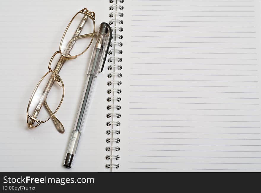 Spectacles with ball pen on open diary. Spectacles with ball pen on open diary