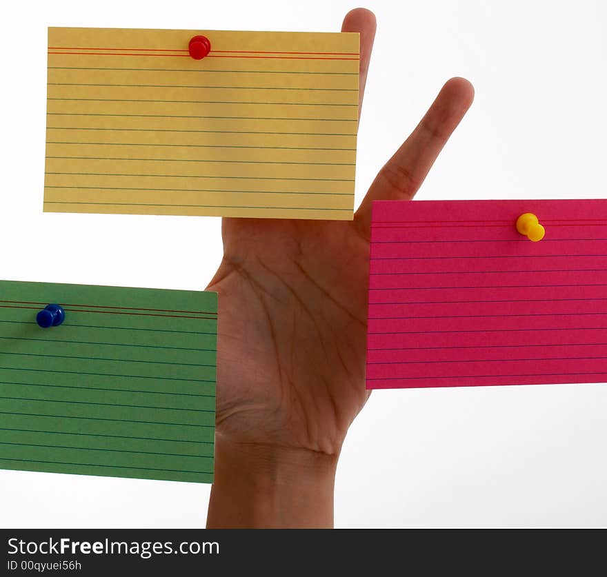 Three blank cards pinned on a hand