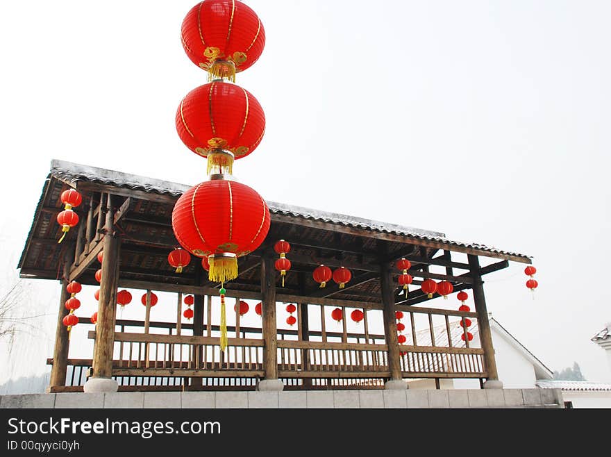 Red latern and wood pavilion on a stone bridge,scenic in a watery town,south eastern china。