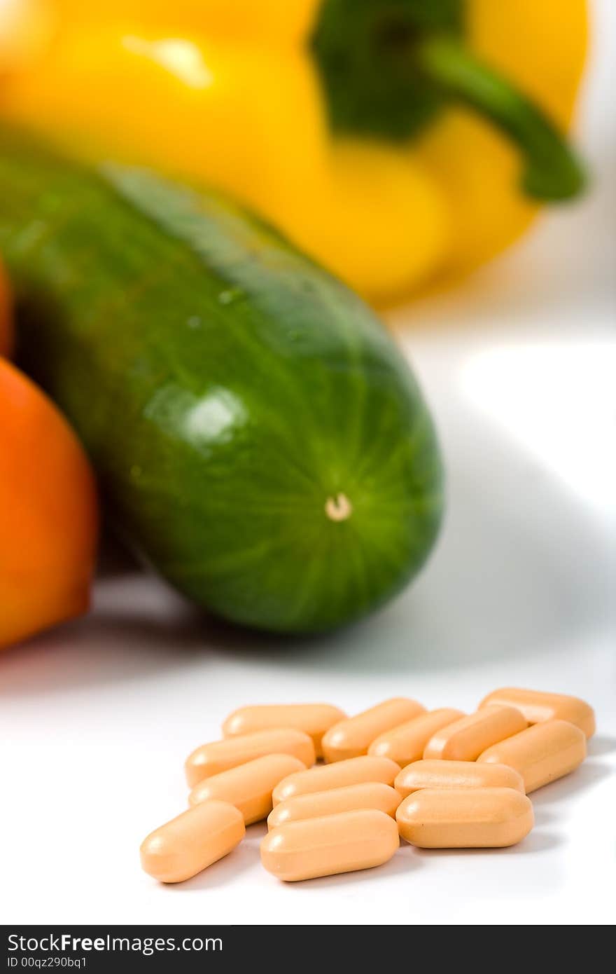 Closeup pills with vegetables