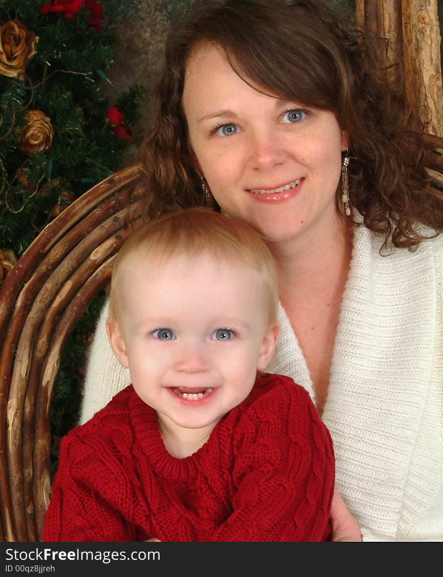 Closeup of mother and toddler smiling and looking at camera. Closeup of mother and toddler smiling and looking at camera