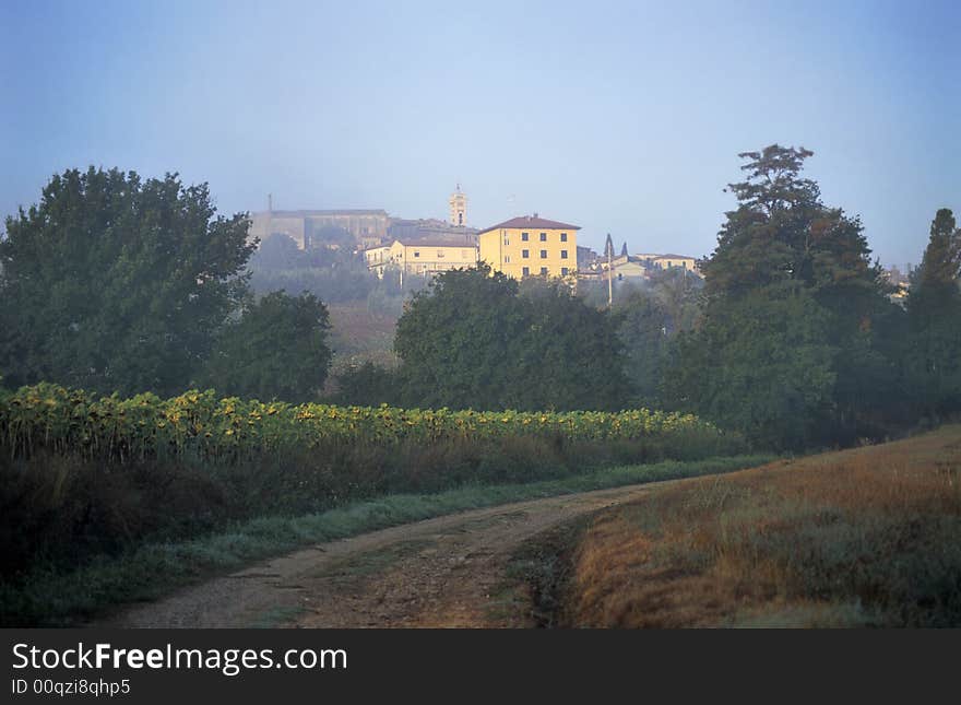 Path with little village at the background, dawn, Italy. Path with little village at the background, dawn, Italy