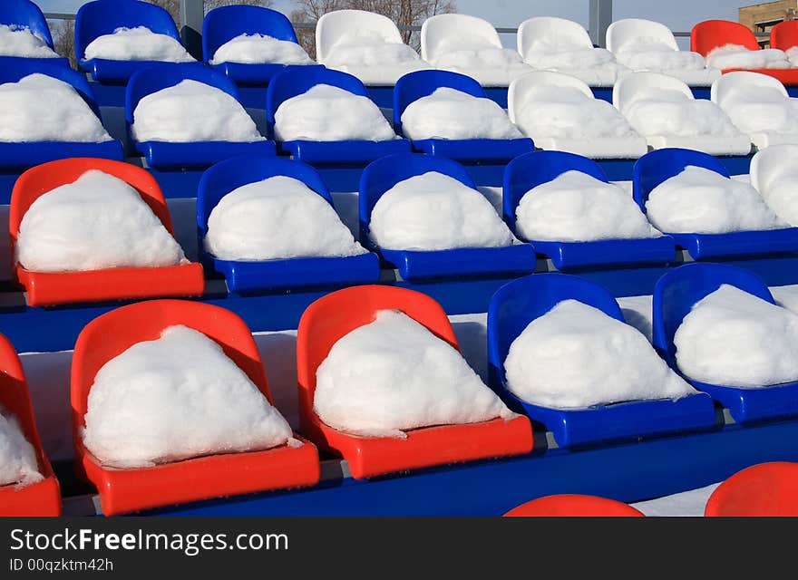 Seats on tribunes of stadium under a snow. Seats on tribunes of stadium under a snow