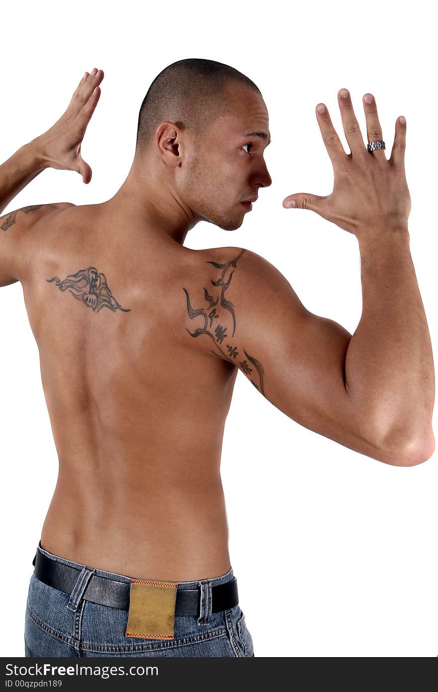 Young man showing his muscles and his tattooed back - isolated over white!. Young man showing his muscles and his tattooed back - isolated over white!