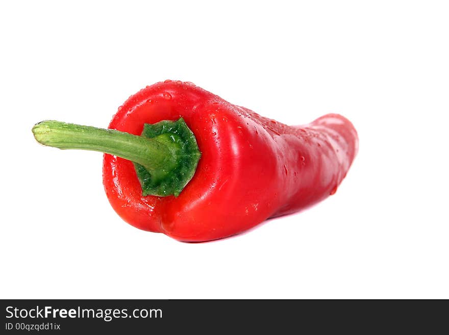 Shot of red pepper with waterdrops on it - over white background.