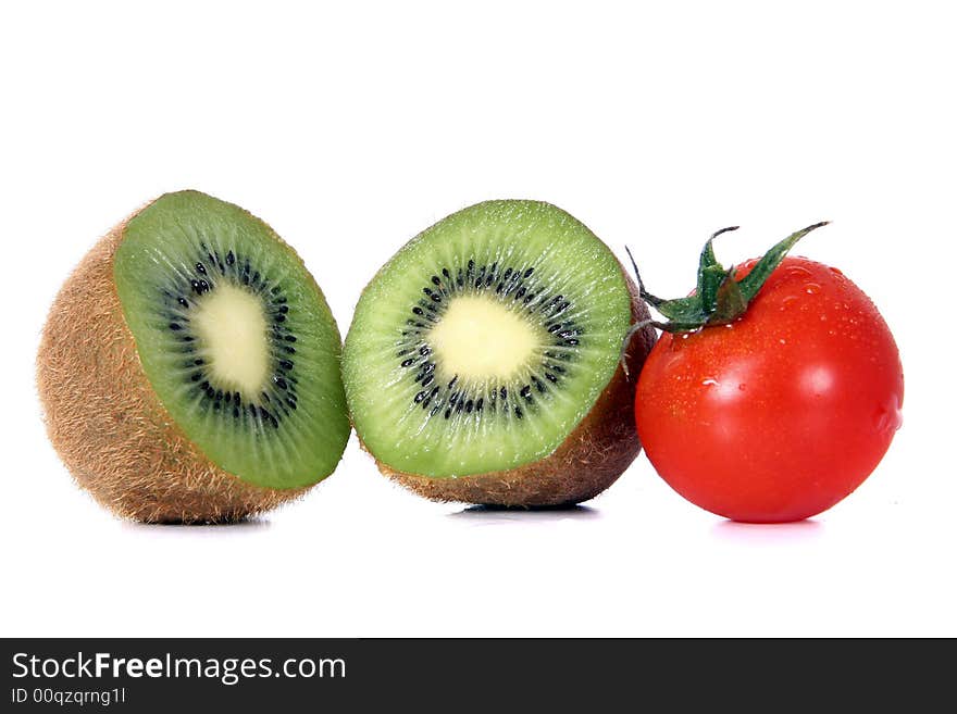 Shot of a green kiwi and a red tomatoe - wet and juicy - over white background. Shot of a green kiwi and a red tomatoe - wet and juicy - over white background.