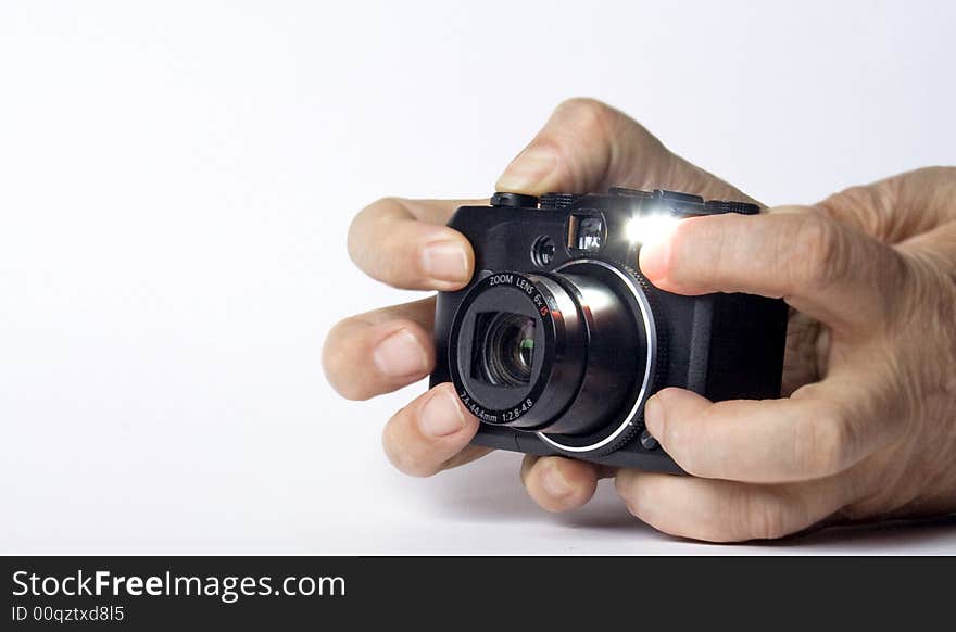 Modern digital camera is working in hands of photographer. Modern digital camera is working in hands of photographer