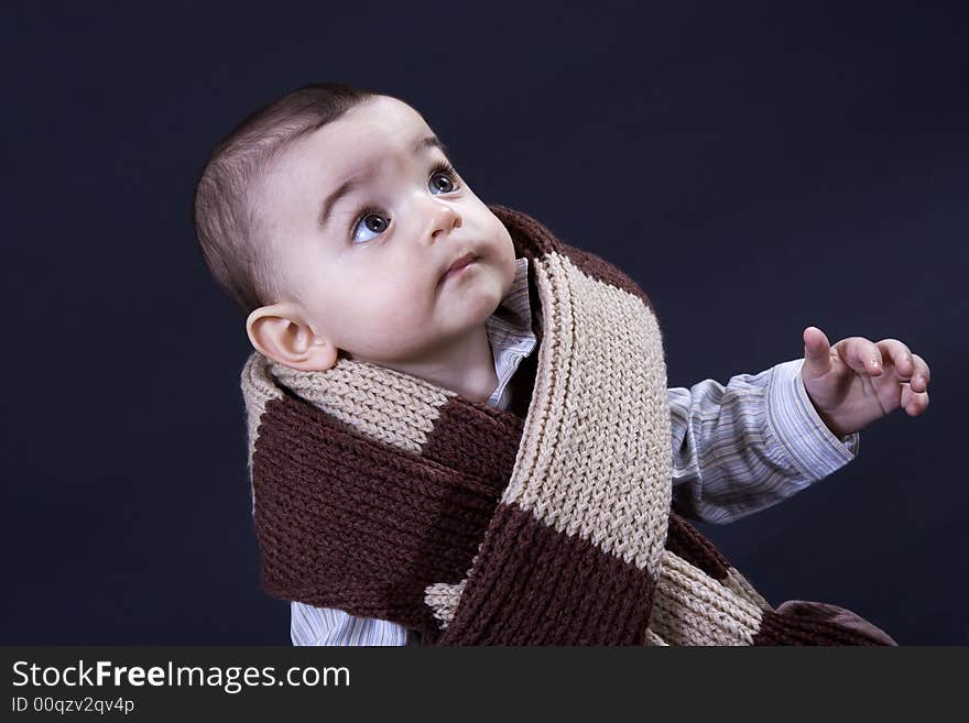 Curious happy baby on black surface