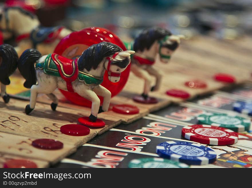 Plastic horse toy, red buttoned, cazino counter in a nice and funny arrangement. Plastic horse toy, red buttoned, cazino counter in a nice and funny arrangement