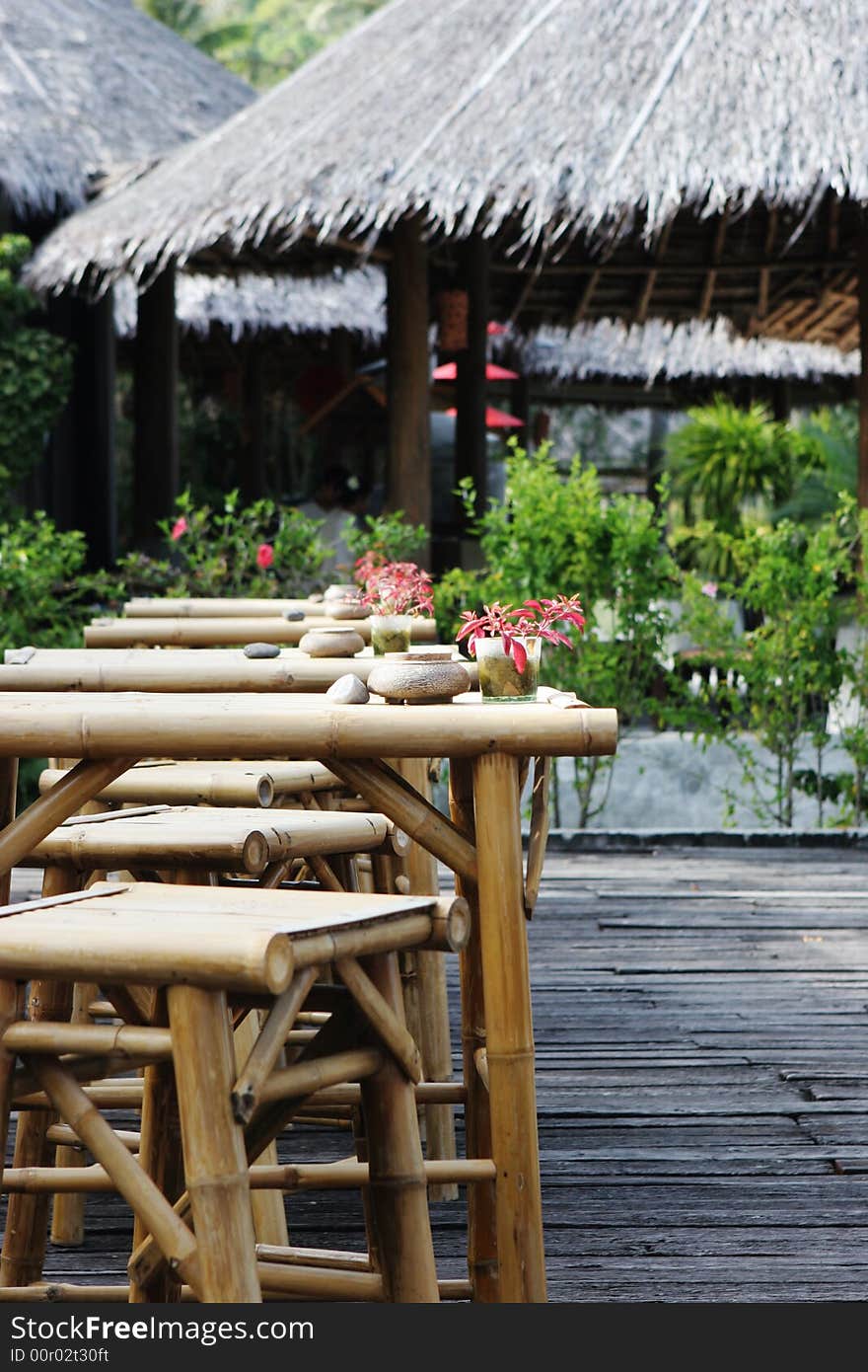 Table and chairs at an outdoor bar in the tropics - travel and tourism.