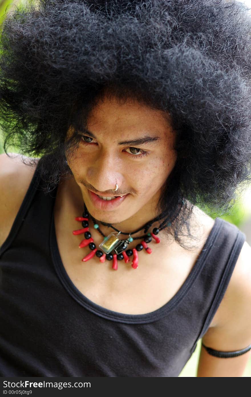 Portrait of a happy Thai man with a big afro.