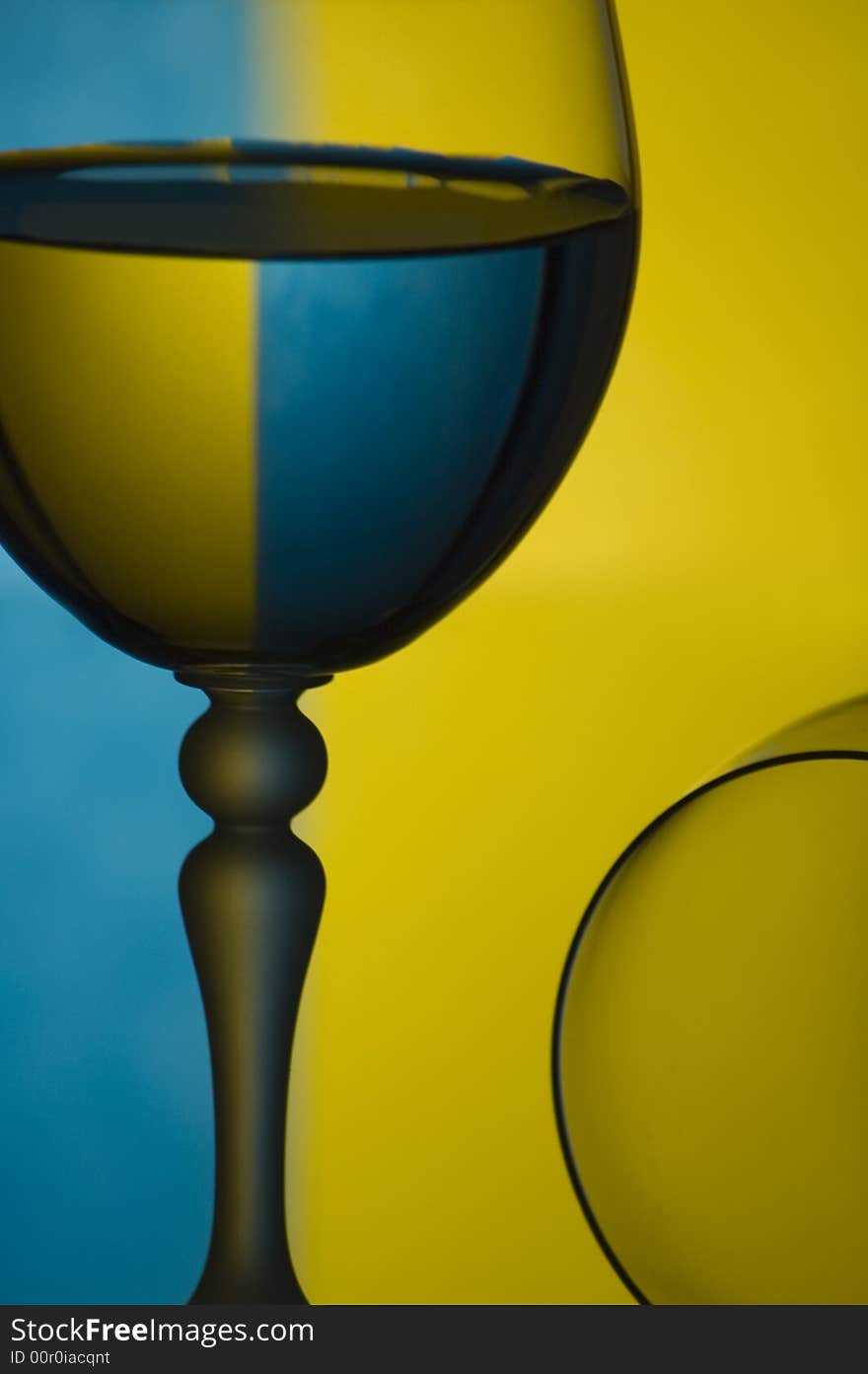 Glass of water with coloured background