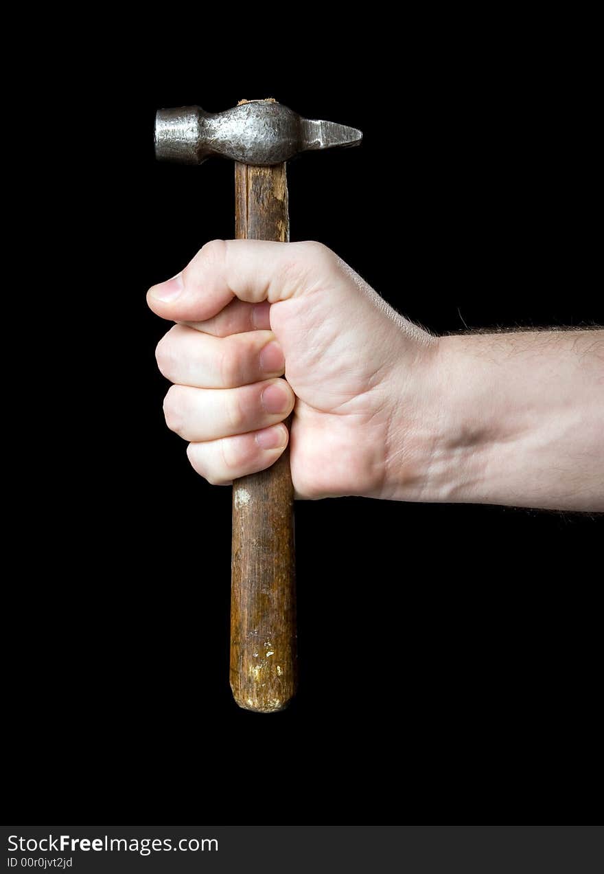 Hammer in a hand on a black background.