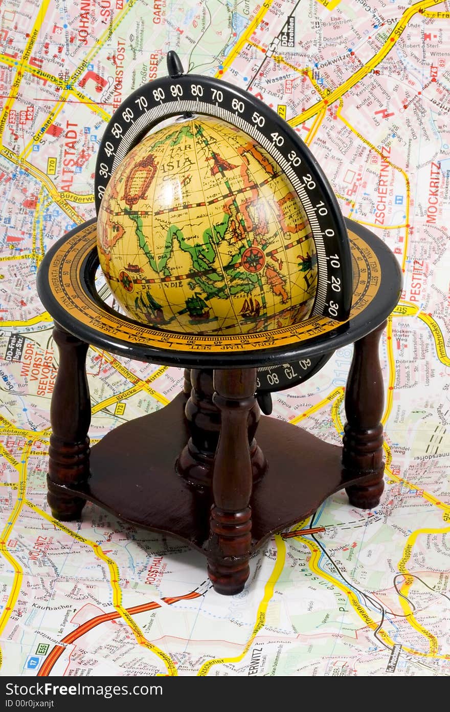 An old globe standing on a map - close up. An old globe standing on a map - close up