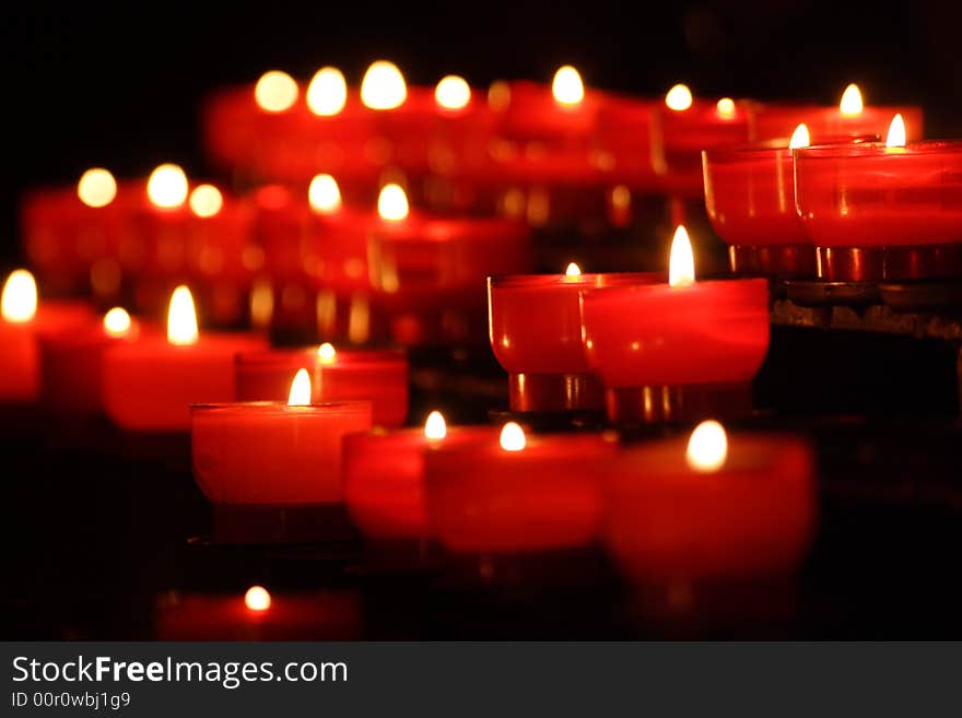 Small candles in rows in a church