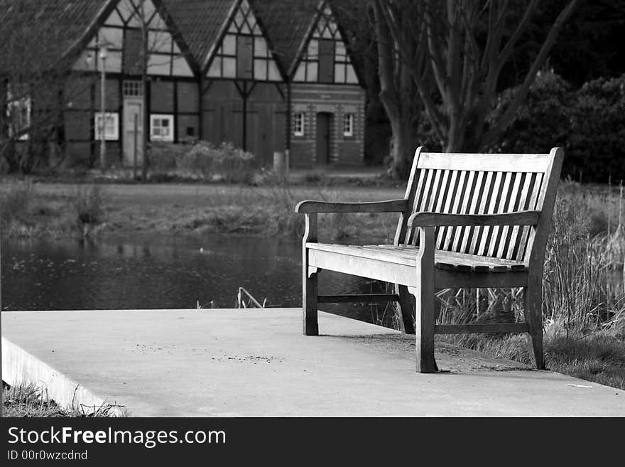 Bench with houses in the background, blanc and white