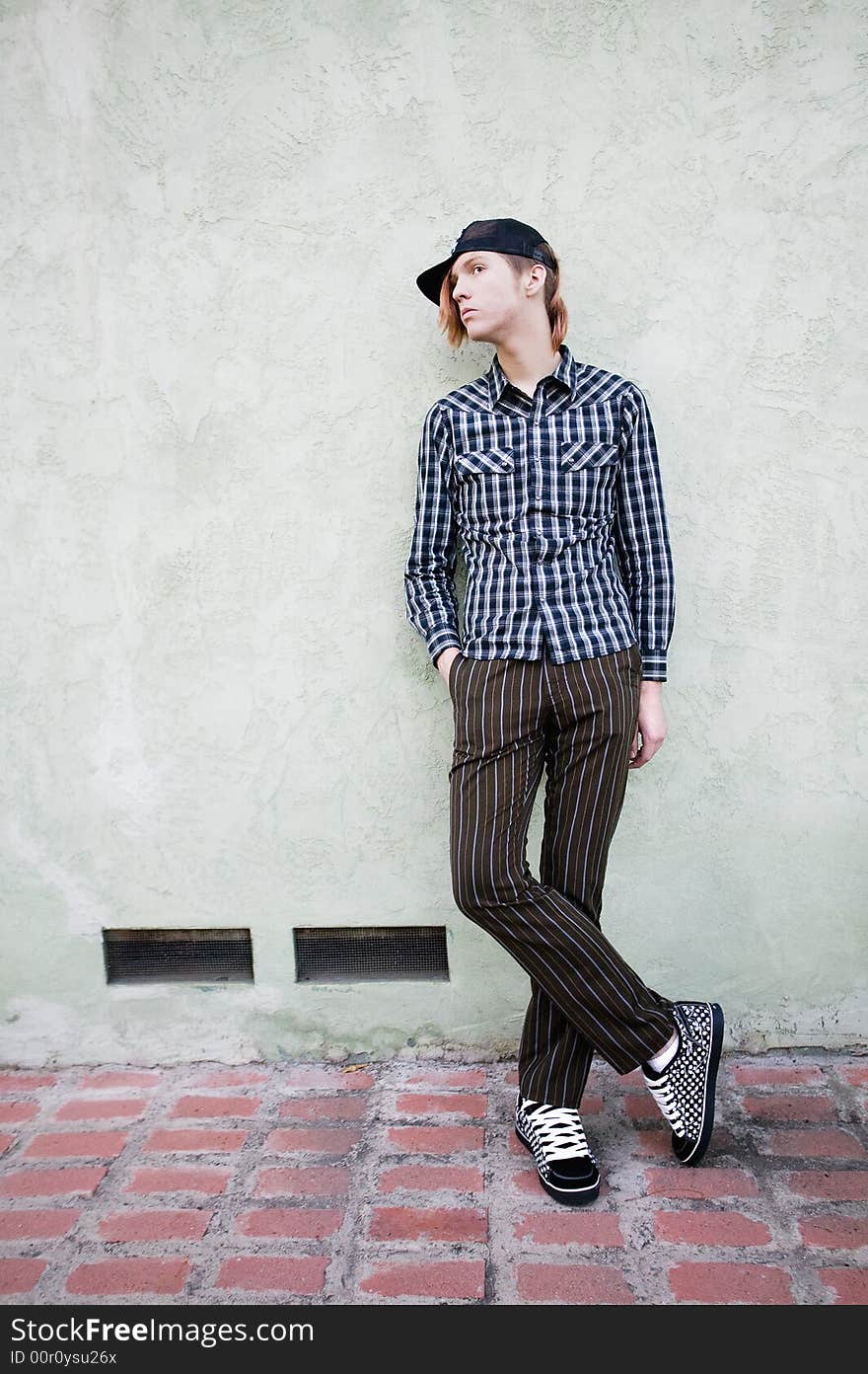 Teenage Boy Leaning Against a Wall