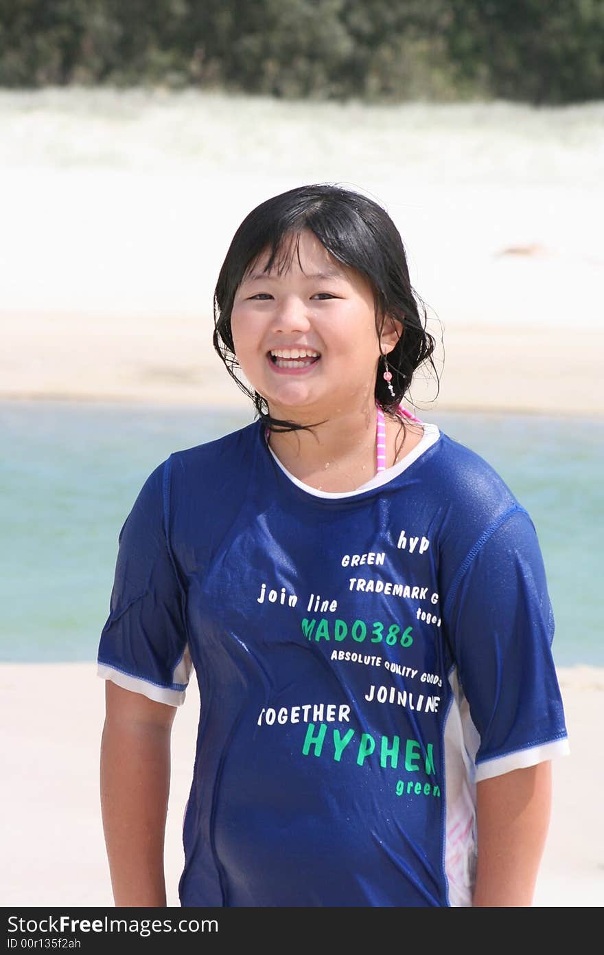 Korean teen girl enjoys the beach and water