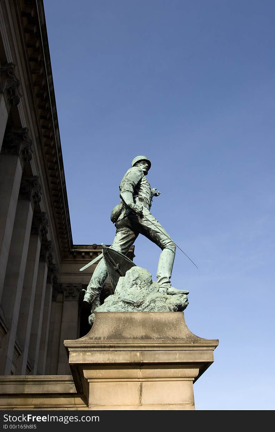 Copper statue of a soldier on a stone plinth with St Georges Hall in the background in Liverpool the capital of culture for 2008. Copper statue of a soldier on a stone plinth with St Georges Hall in the background in Liverpool the capital of culture for 2008