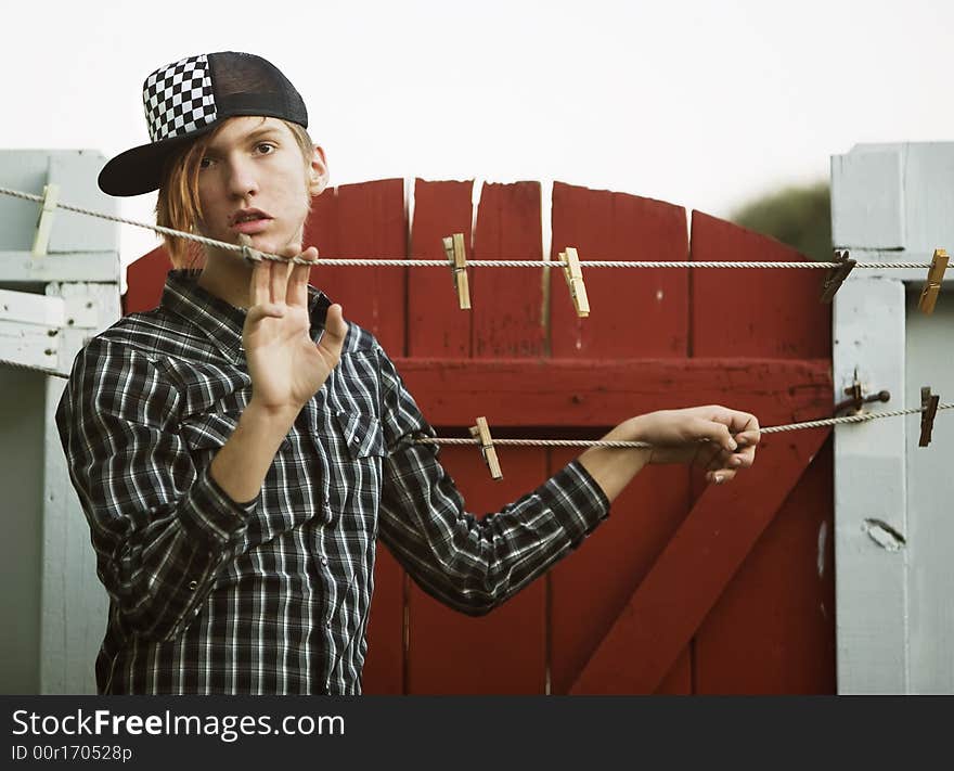 Teenage Boy Leaning on a Clothesline