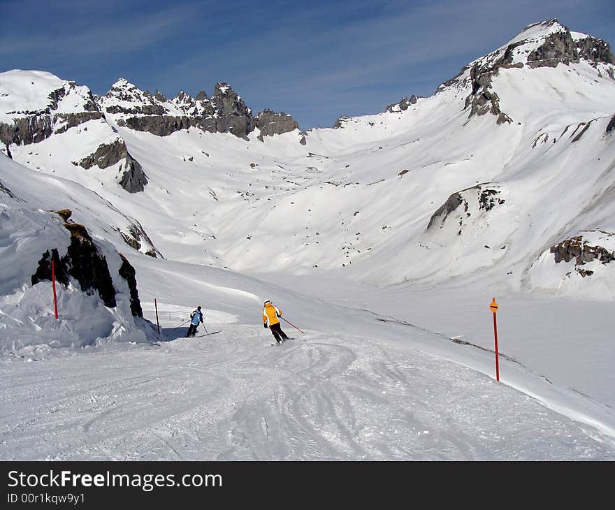 Ski run between rugged rocky mountains in the ski area of Flims Laax in the east of Switzerland. Ski run between rugged rocky mountains in the ski area of Flims Laax in the east of Switzerland.