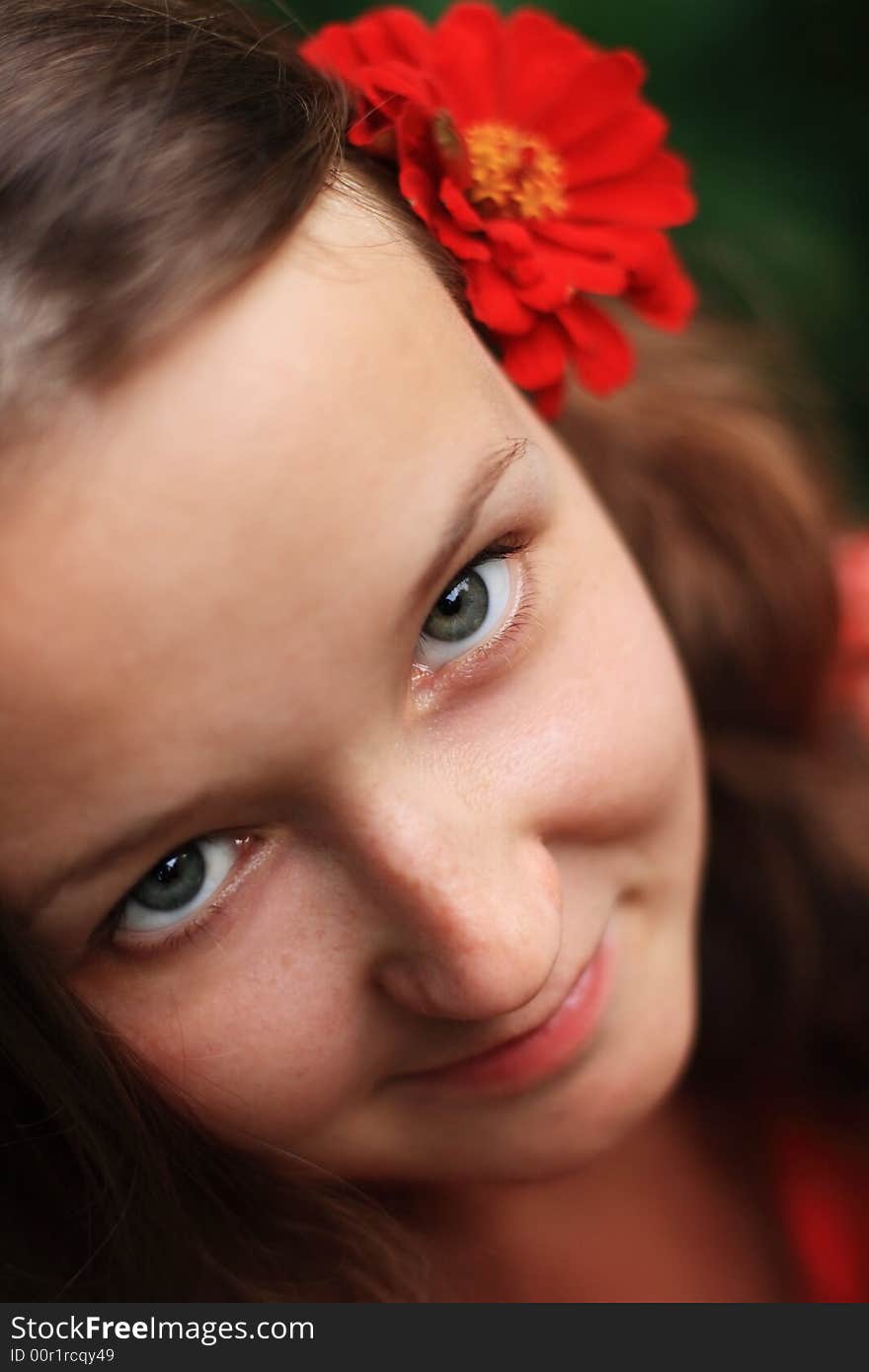 Young girl smile with red flower in a hair. Young girl smile with red flower in a hair.