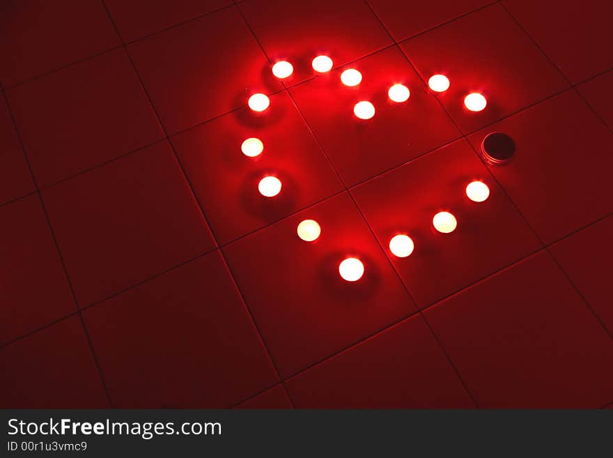 Candle Heart with lights on the red background. Candle Heart with lights on the red background