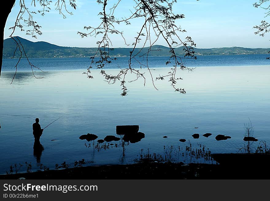 Man fishing in the lake solitude. Man fishing in the lake solitude