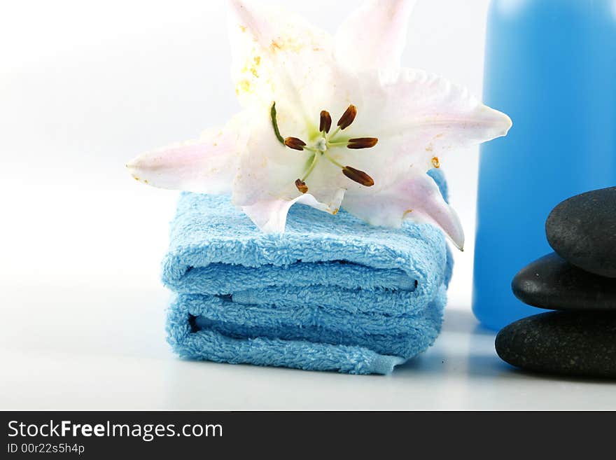 Blue towels and fresh lily on white color background