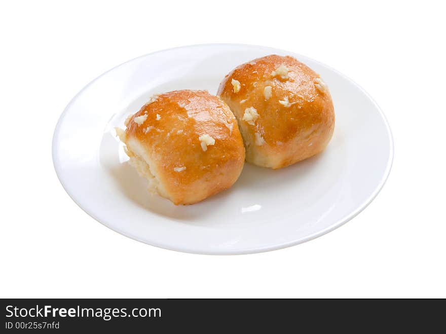 Two buns in white plate on white background, isolated. Two buns in white plate on white background, isolated