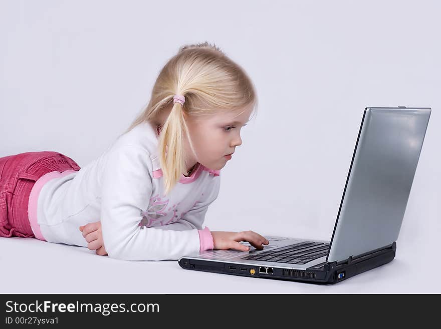 Girl lieing on the floor and using laptop. Girl lieing on the floor and using laptop