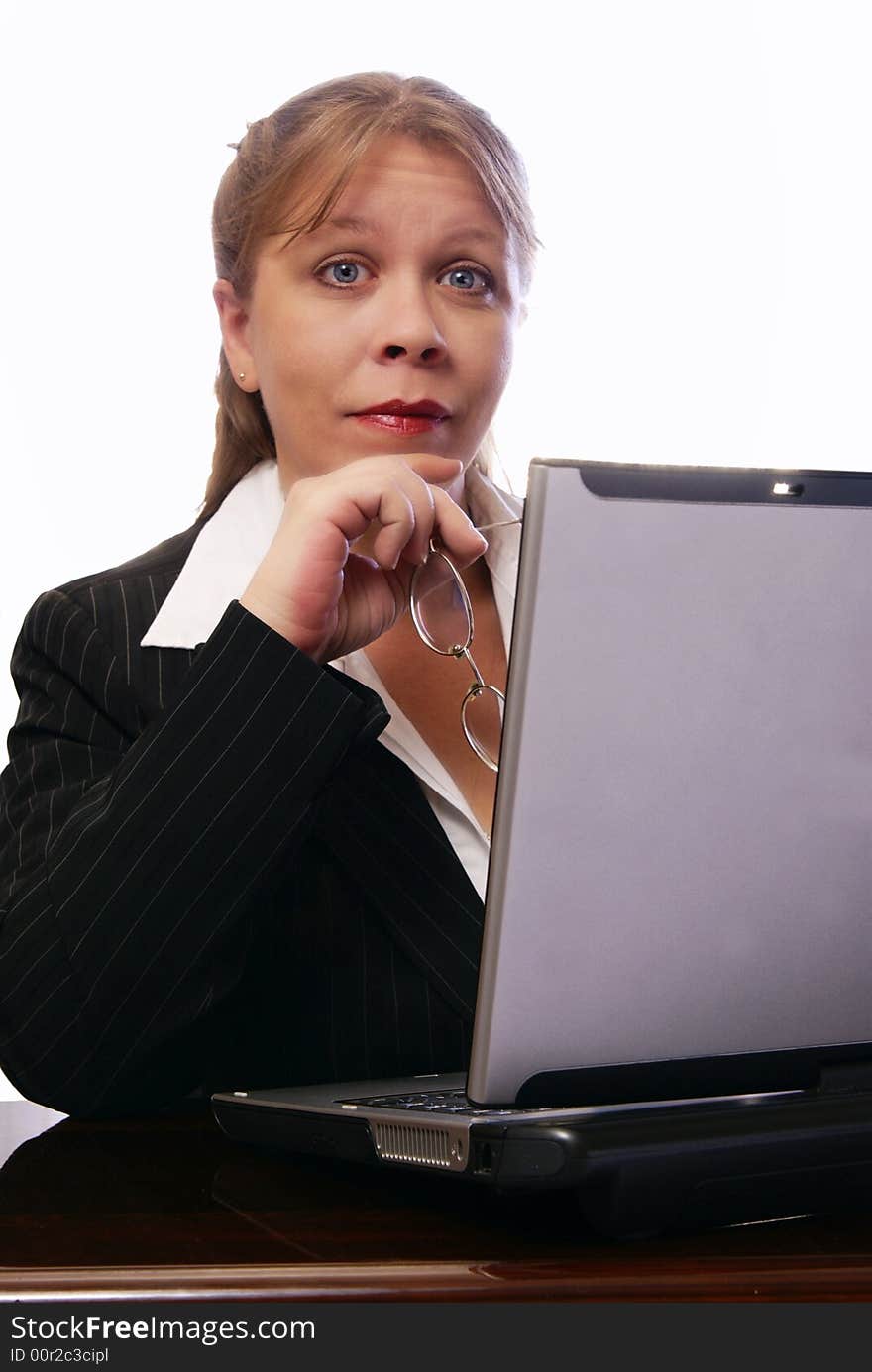 Professional woman working on convertible notebook laptop computer looking at viewer with raised eyebrows. Natural look with minimal makeup. Professional woman working on convertible notebook laptop computer looking at viewer with raised eyebrows. Natural look with minimal makeup.