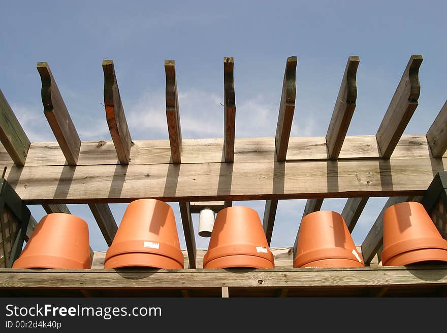 Flower pots lined in a row outdoors before the busy Spring planting season. Flower pots lined in a row outdoors before the busy Spring planting season.