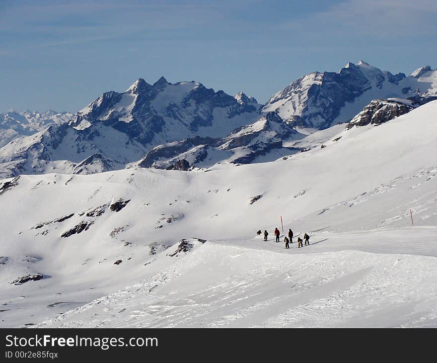 Ski run between rugged rocky mountains in the ski area of Flims Laax in the east of Switzerland. The mountains in the background are named Hausstock 3158 m / 10360 ft. and Bifertenstock 3421 m / 11224 ft. Ski run between rugged rocky mountains in the ski area of Flims Laax in the east of Switzerland. The mountains in the background are named Hausstock 3158 m / 10360 ft. and Bifertenstock 3421 m / 11224 ft.