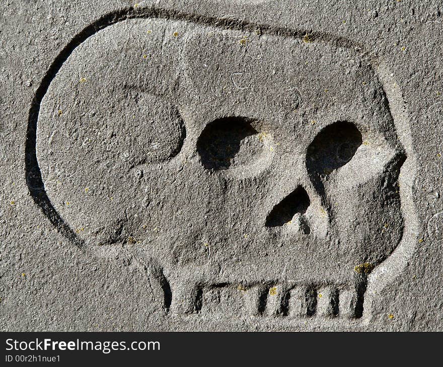 A skull engraving on a tombstone