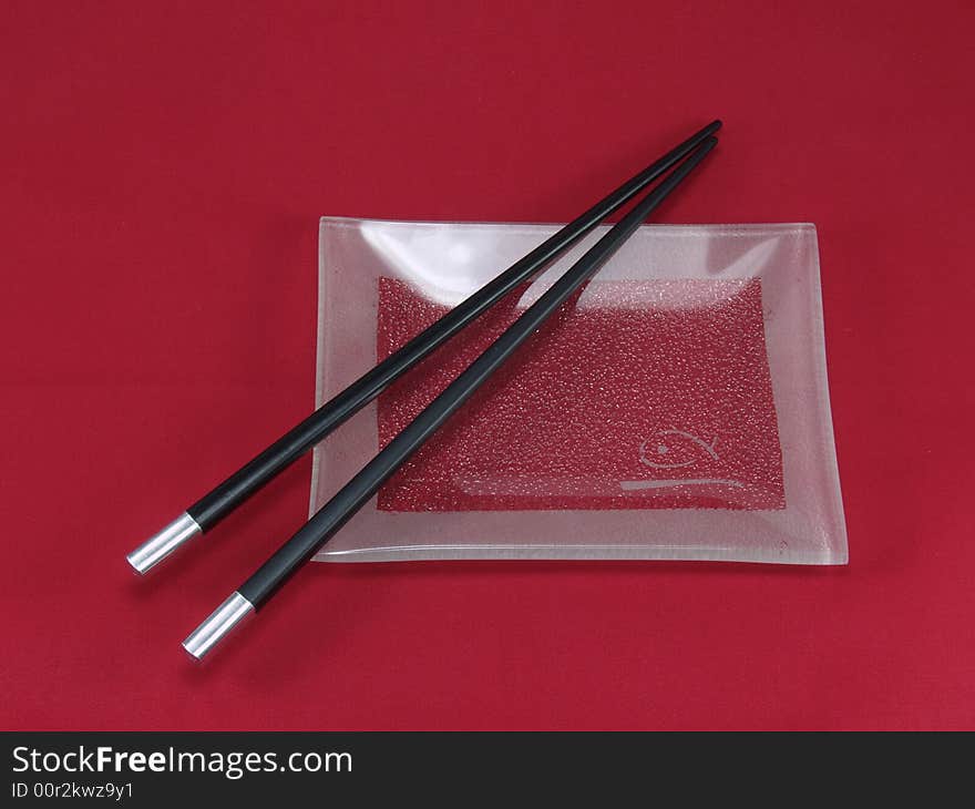 Chopsticks for a sushi on a red background