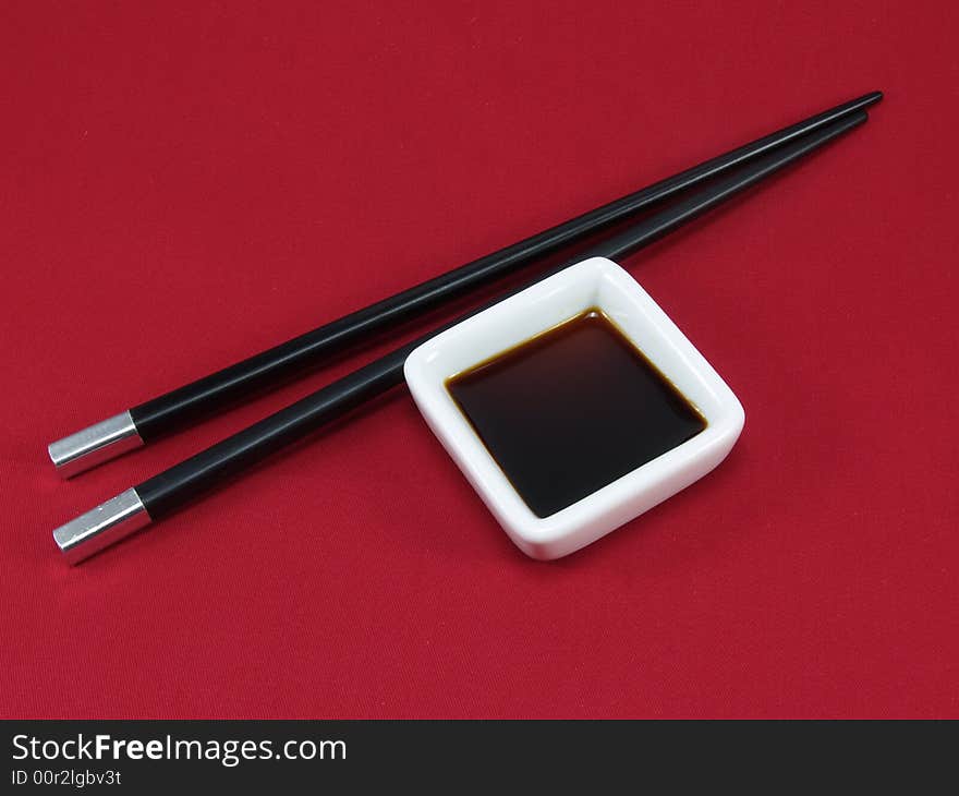 Chopsticks for a sushi on a red background