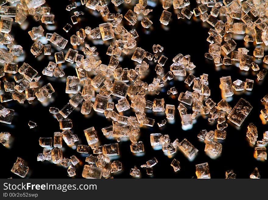 Transparent crystals are falling on black