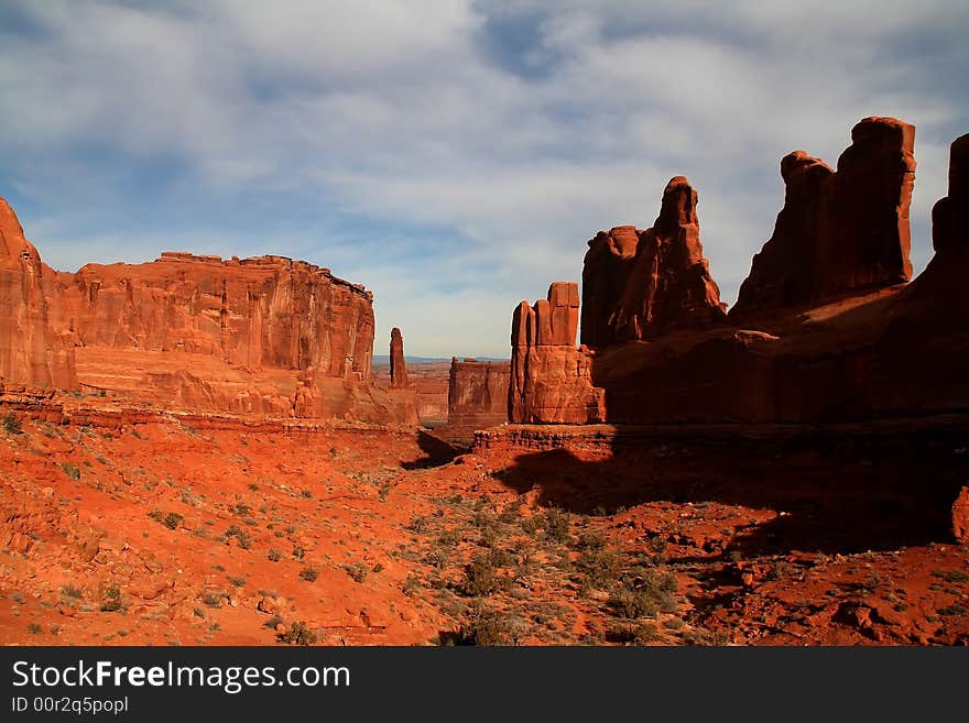 View of the red rock formations in Arches National Park with blue sky�s and clouds. View of the red rock formations in Arches National Park with blue sky�s and clouds