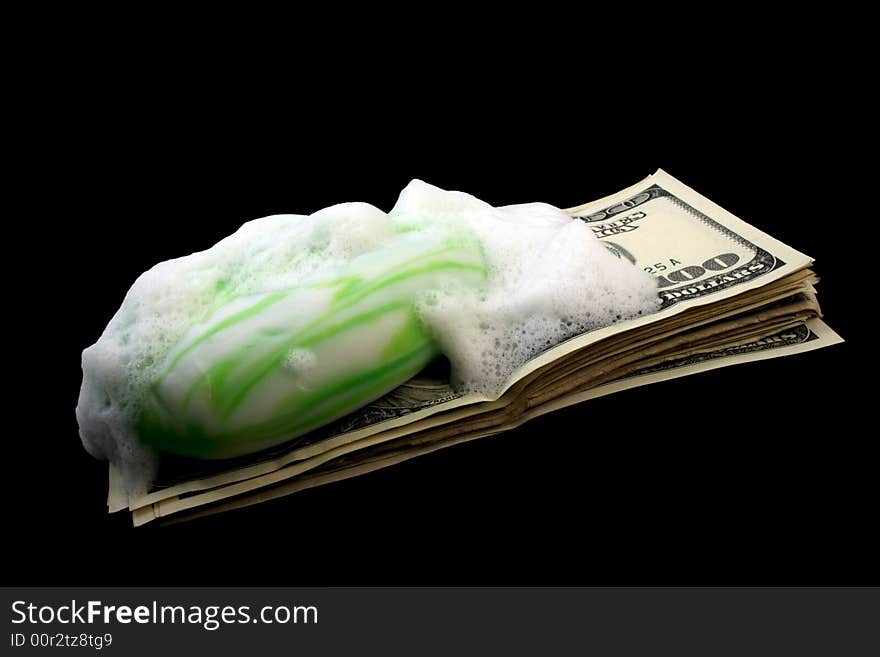 Dirty money with soap and foam isolated on black