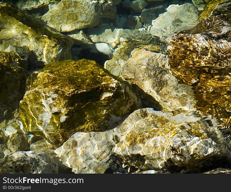 Transparent water and stones useful as texture or background. Transparent water and stones useful as texture or background